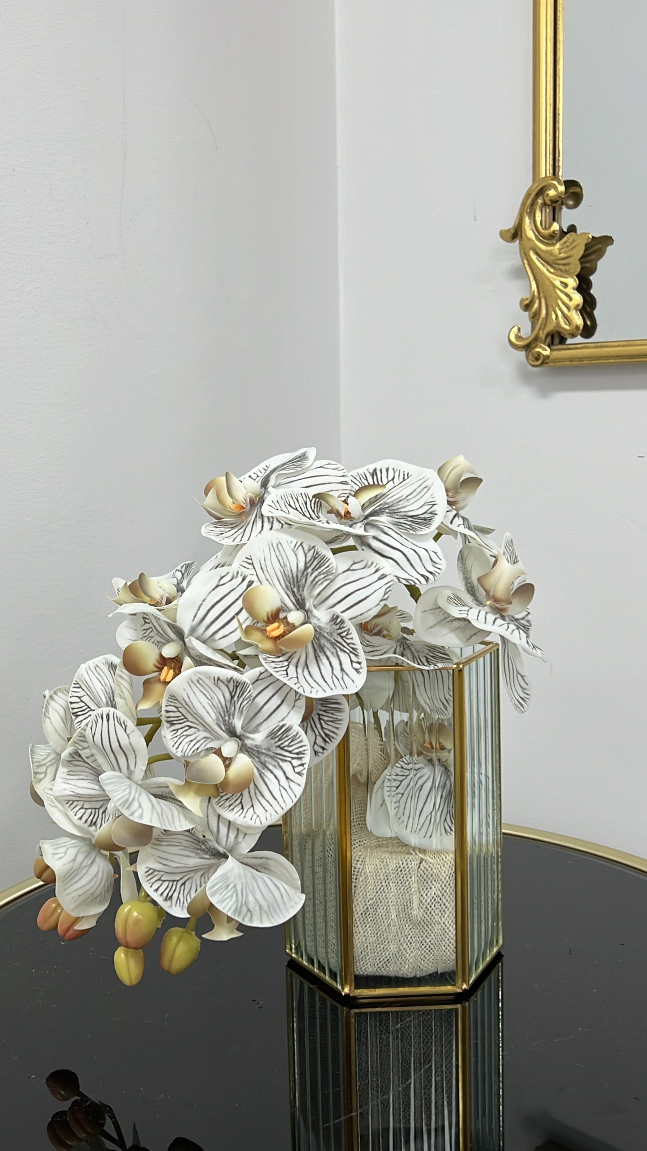 Gold ribbed glass vase and orchids