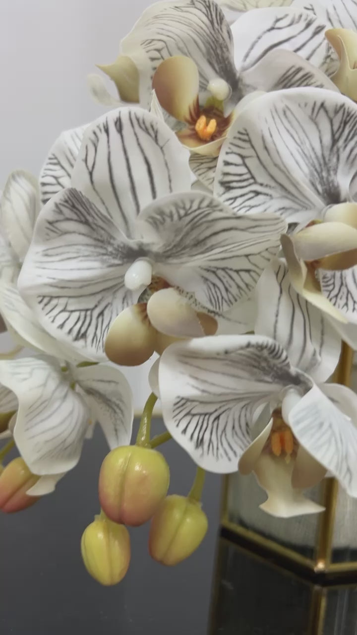 Gold ribbed glass vase and orchids